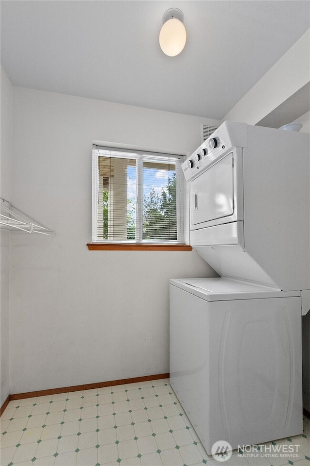 236 W Maberry Dr Unit 102, Lynden, WA 98264 - washroom featuring stacked washer / dryer, light flooring, and baseboards