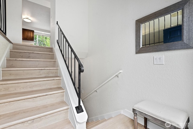 stairs featuring baseboards and wood finished floors