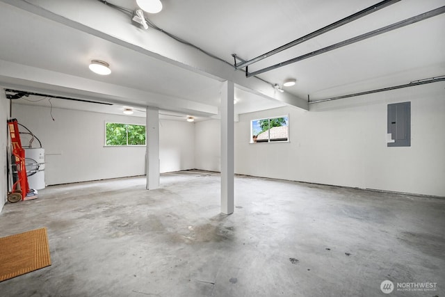garage featuring water heater and electric panel