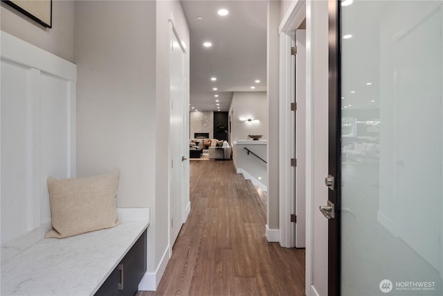 corridor featuring wood finished floors and recessed lighting