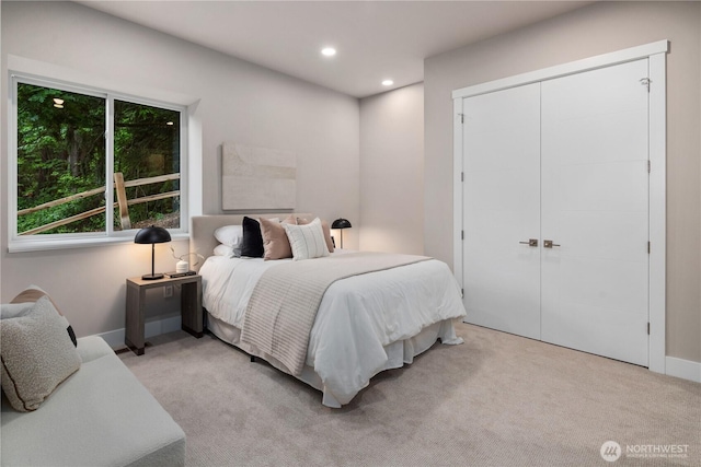 carpeted bedroom with recessed lighting and a closet