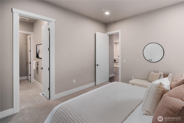 bedroom with baseboards, light carpet, recessed lighting, and ensuite bath
