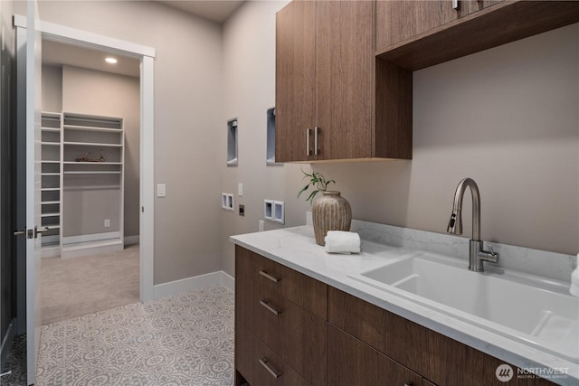 laundry area with electric dryer hookup, hookup for a washing machine, cabinet space, baseboards, and light carpet