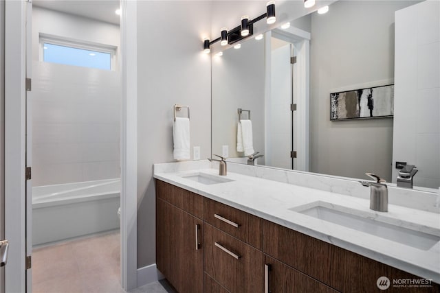 bathroom featuring double vanity, toilet, and tile patterned flooring