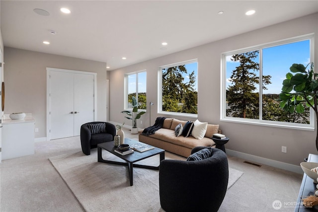 living room featuring light carpet, recessed lighting, and baseboards