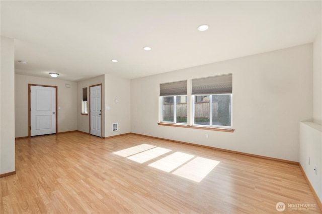 unfurnished room featuring baseboards, light wood-style floors, and recessed lighting