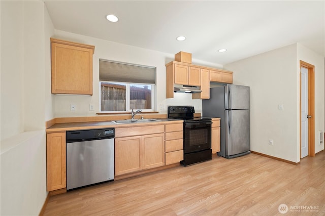 kitchen featuring stainless steel appliances, light brown cabinets, a sink, under cabinet range hood, and light wood finished floors