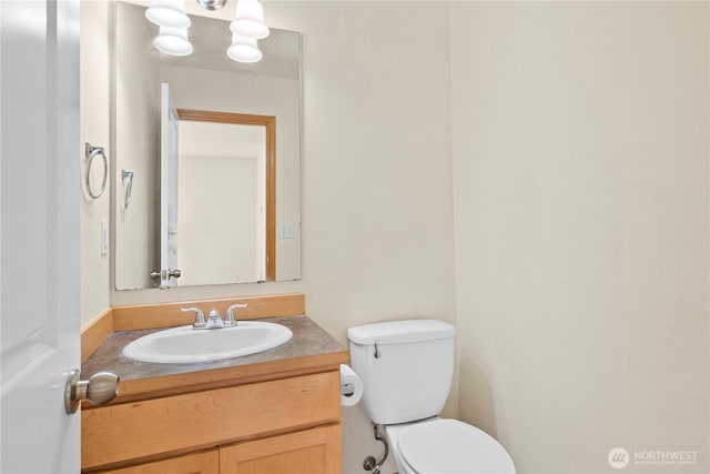 bathroom with toilet and vanity