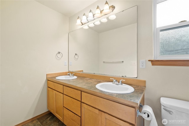 full bath featuring toilet and double vanity