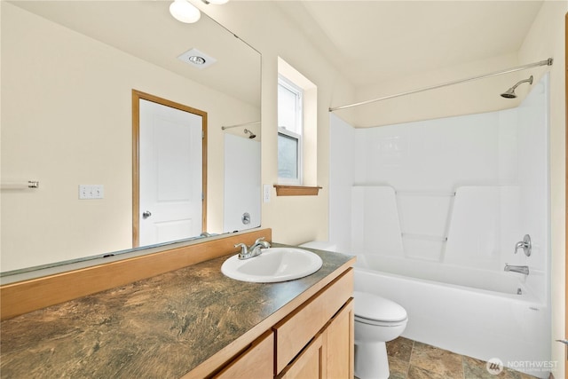 bathroom with vanity, shower / bath combination, and toilet