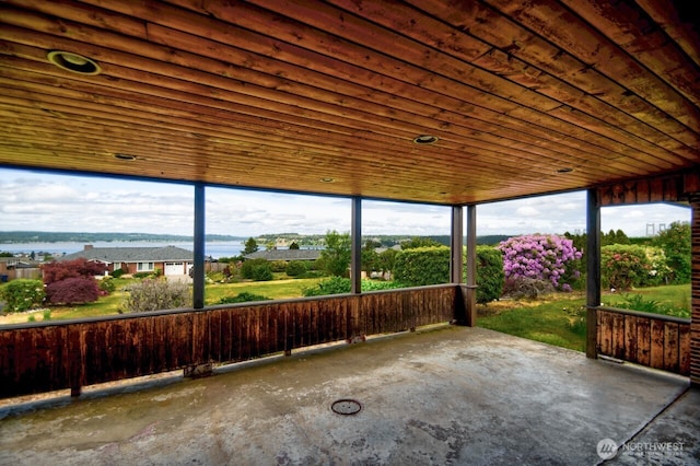 1260 S Karl Johan Ave, Tacoma, WA 98465 - unfurnished sunroom featuring unfinished concrete flooring and wooden ceiling