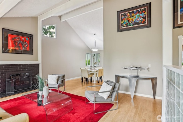 living area featuring wood finished floors, a fireplace, and baseboards