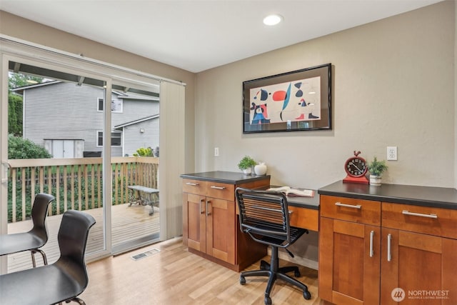 office with light wood finished floors and recessed lighting
