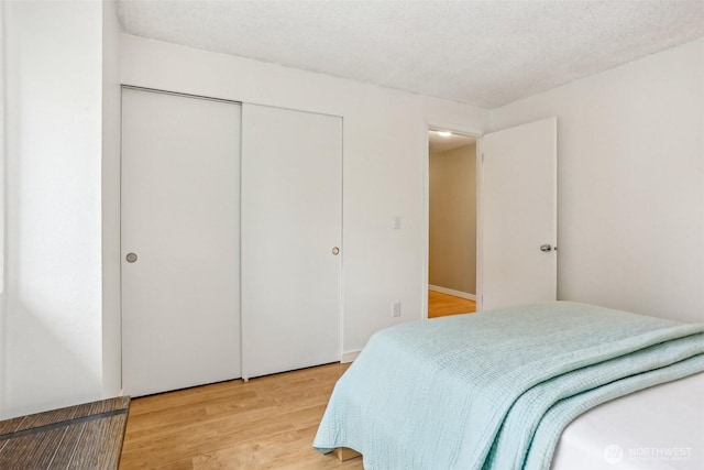 bedroom featuring light wood-style flooring and a closet