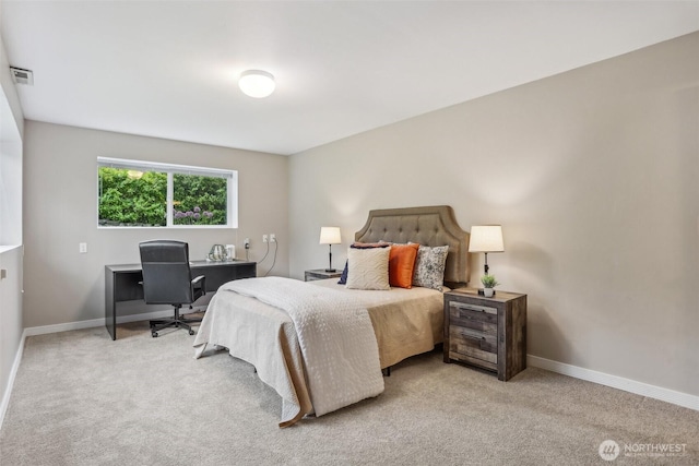 bedroom with carpet, an office area, and baseboards
