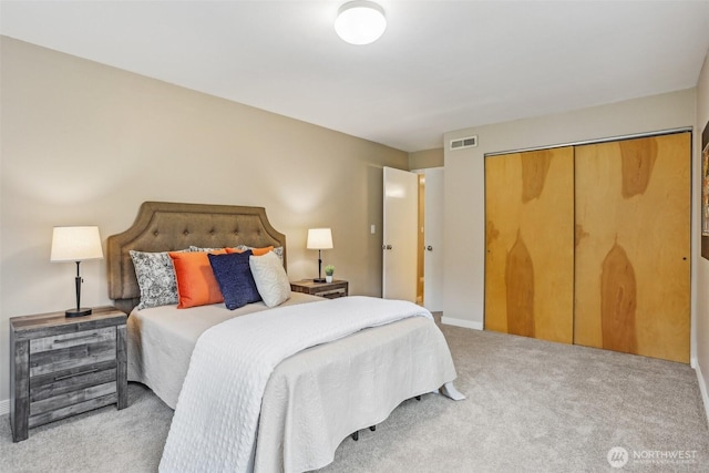 bedroom featuring carpet, baseboards, and a closet