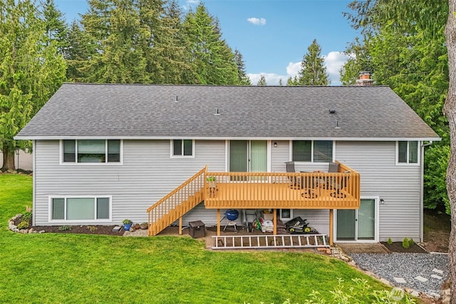 back of property with roof with shingles, a deck, a chimney, a yard, and stairs