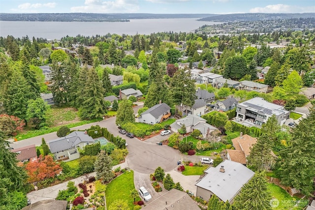 aerial perspective of suburban area with a nearby body of water