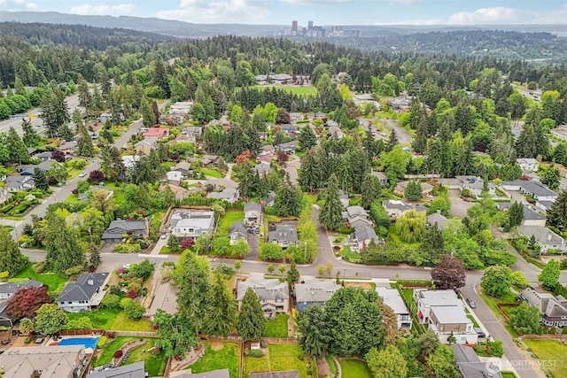 aerial perspective of suburban area featuring a heavily wooded area