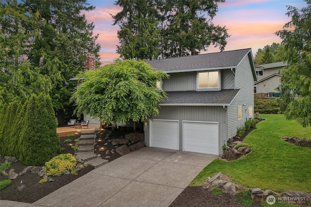 view of front of house featuring roof with shingles, a lawn, concrete driveway, an attached garage, and a chimney