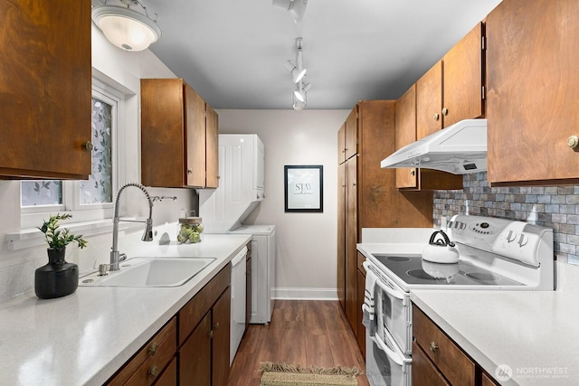 11515 Greenwood Ave N Unit B, Seattle, WA 98133 - kitchen featuring white appliances, under cabinet range hood, stacked washing machine and dryer, and light countertops