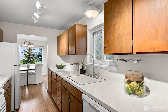 11515 Greenwood Ave N Unit B, Seattle, WA 98133 - kitchen with white appliances, light countertops, light wood-style flooring, and brown cabinetry