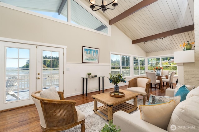 9788 Manitou Beach Dr NE, Bainbridge Island, WA 98110 - living area featuring beamed ceiling, wood finished floors, a chandelier, high vaulted ceiling, and french doors