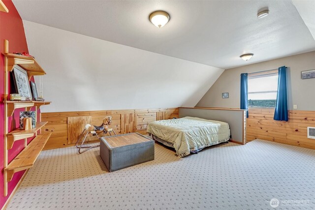 545 Sagebrush Dr, Ephrata, WA 98823 - carpeted bedroom featuring wood walls, vaulted ceiling, and a wainscoted wall