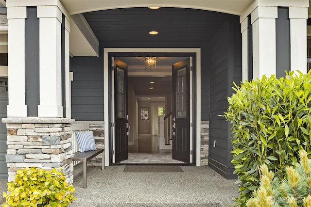 property entrance featuring stone siding