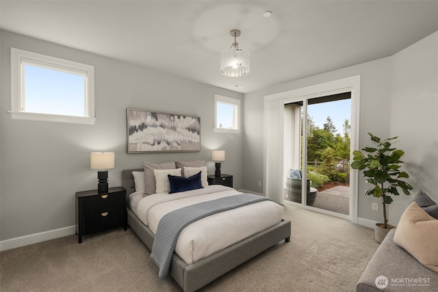 carpeted bedroom featuring access to outside and baseboards