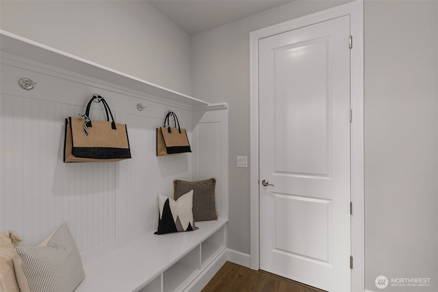 mudroom with dark wood-style flooring and baseboards