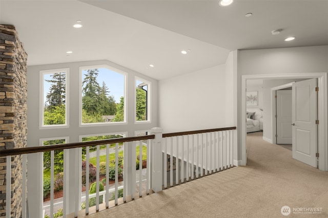 hallway featuring carpet, lofted ceiling, and recessed lighting
