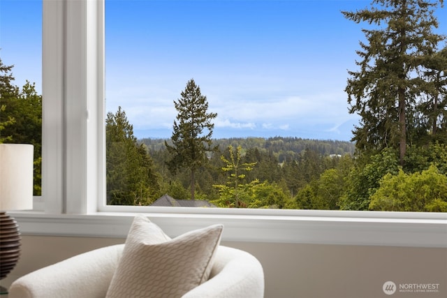 balcony featuring a wooded view