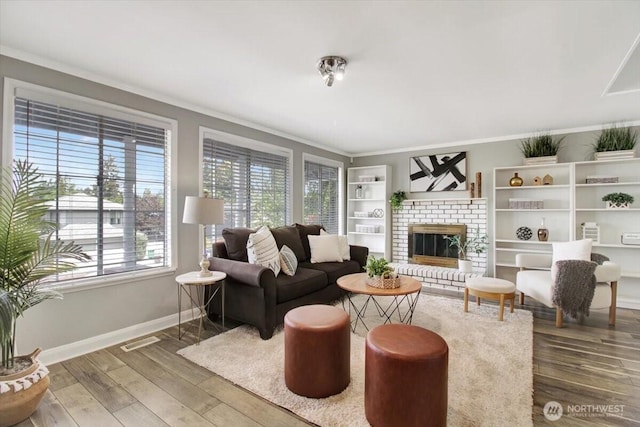 2711 NE 4th Ct, Renton, WA 98056 - living area with crown molding, baseboards, wood finished floors, and a fireplace