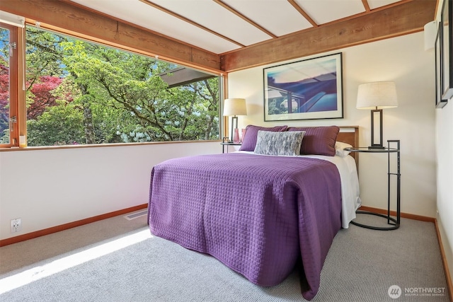 carpeted bedroom with baseboards and multiple windows