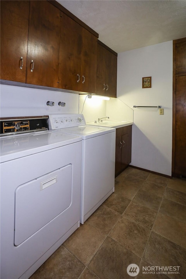 washroom with cabinet space and washing machine and dryer