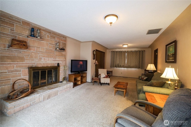 living room with carpet floors and a stone fireplace