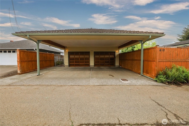 garage featuring a garage and fence