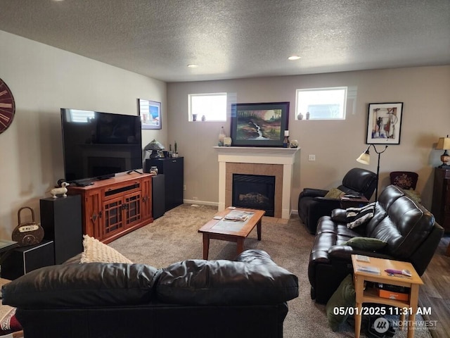 13816 NE 63rd St, Vancouver, WA 98682 - living area with a tile fireplace, a textured ceiling, carpet floors, baseboards, and recessed lighting
