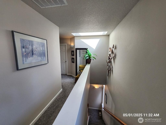 13816 NE 63rd St, Vancouver, WA 98682 - hallway with an upstairs landing, carpet flooring, a skylight, baseboards, and a textured ceiling