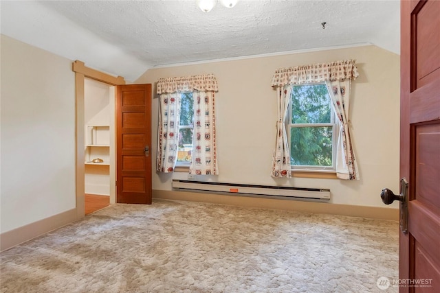 1420 S Verde St, Tacoma, WA 98405 - carpeted empty room featuring a baseboard radiator, vaulted ceiling, a textured ceiling, and baseboards
