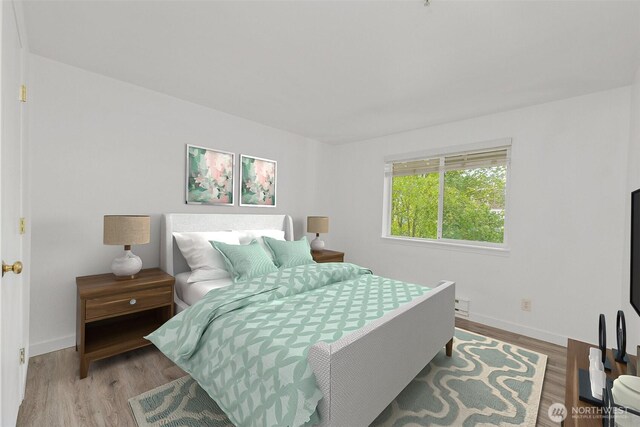 bedroom featuring baseboards and wood finished floors