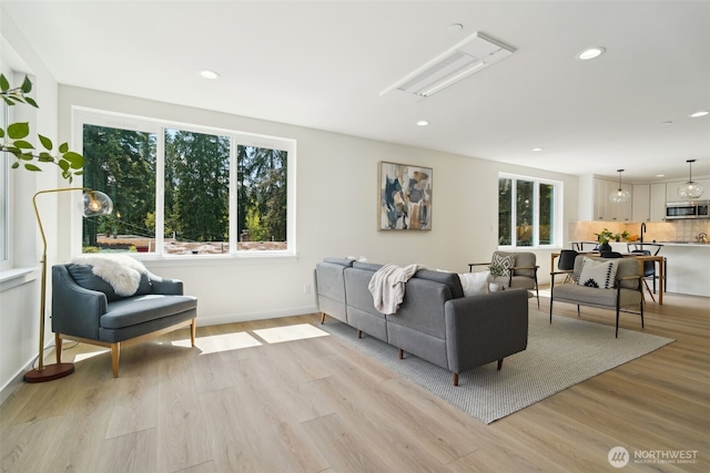 20311 14th Ave NE Unit A, Shoreline, WA 98155 - living room with healthy amount of natural light, recessed lighting, light wood finished floors, and baseboards