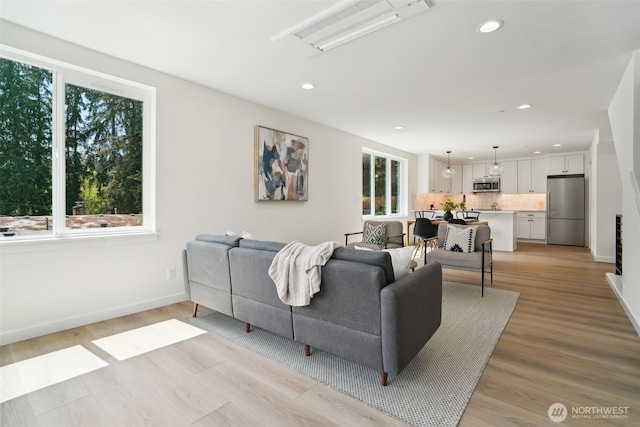 20311 14th Ave NE Unit A, Shoreline, WA 98155 - living area with healthy amount of natural light, recessed lighting, light wood-style flooring, and baseboards