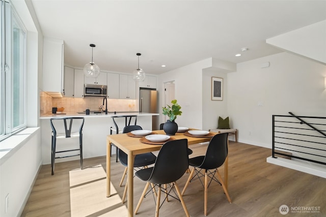 20311 14th Ave NE Unit A, Shoreline, WA 98155 - dining space with light wood-style floors, recessed lighting, and baseboards
