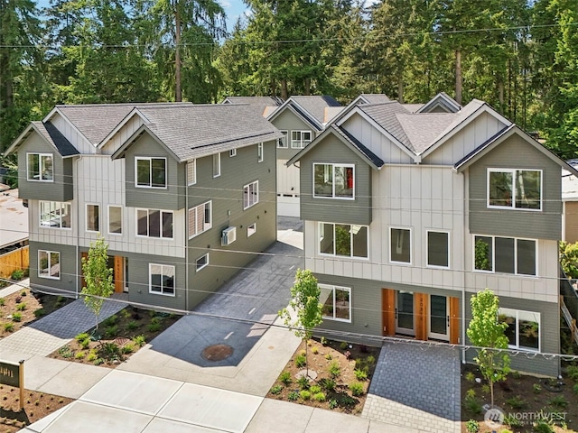 20311 14th Ave NE Unit A, Shoreline, WA 98155 - view of front of house featuring board and batten siding, concrete driveway, and roof with shingles