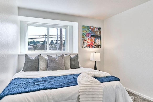 bedroom featuring baseboards and carpet