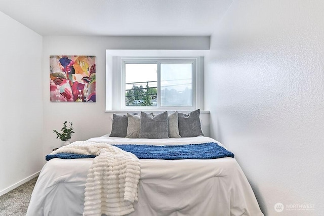 carpeted bedroom featuring baseboards
