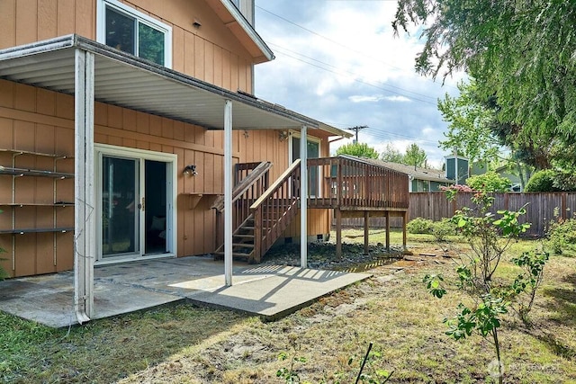 back of house with fence, a patio area, a deck, and stairs