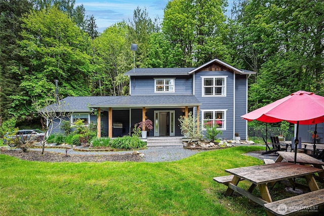 35717 321st St NE, Arlington, WA 98223 - rear view of house featuring covered porch, a yard, and a shingled roof